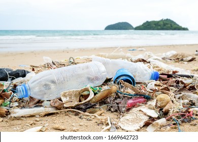 Beach pollution. Plastic bottles and other trash on sea beach. Ecological concept
