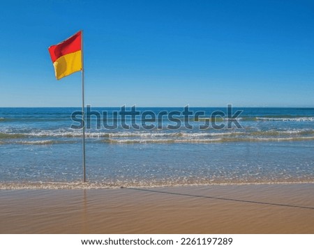 Beach with red and yellow safe swimming flag in Australia