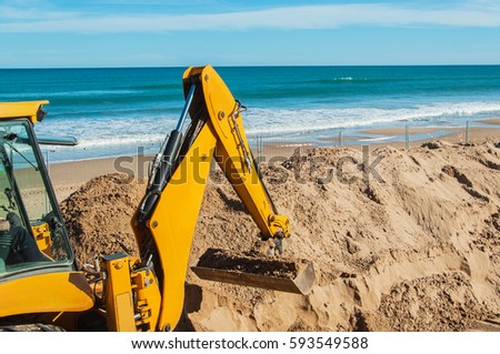 Beach renovation with heavy excavator machine, Spain