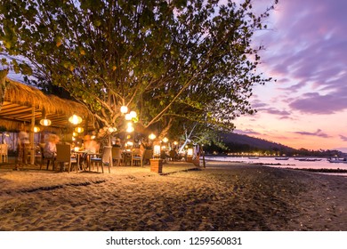 Beach restaurant in front of sea in Bali at sunset