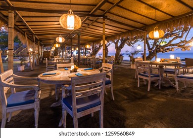 Beach restaurant in front of sea in Bali at sunset