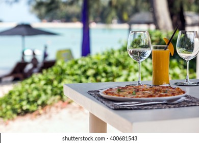 Beach Restaurant With Sea View, Glasses, Plates, Food, Tropical Cocktail With Mango And Pizza Margarita