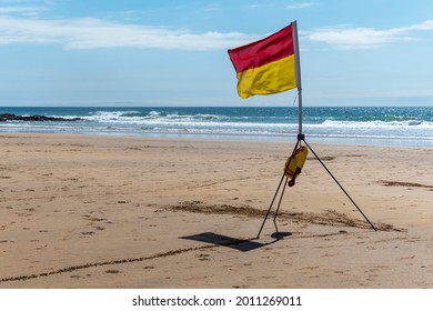 Beach Safety Flag On Sunny Day At Seaside