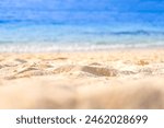 Beach sand background for summer vacation concept. Beach nature and summer seawater with sunlight light sandy beach Sparkling sea water contrast with the blue sky.