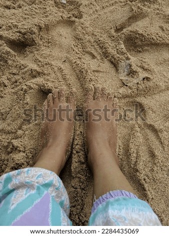 beach sand and dirty bare feet
