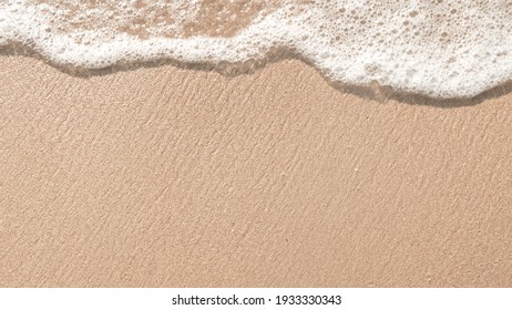 Beach sand sea water summer background.
Sand beach desert texture.
White foam wave sandy seashore top view.