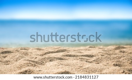 Beach sand sea water summer background. Sand beach desert texture.
White foam wave sandy seashore .  side view. 