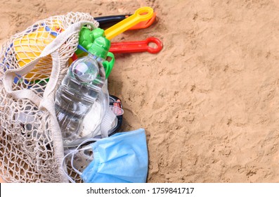 Beach Sand With Toys For The Baby, Water, The Word Holi Stay In Colored Letters. Staycation Content