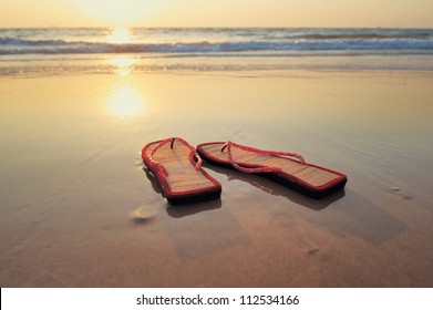 Beach Sandals On The Sandy Beach At The Sea