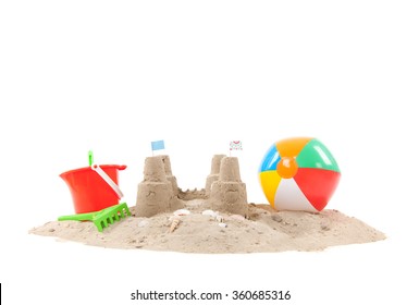 Beach with sandcastle and toys isolated over white background