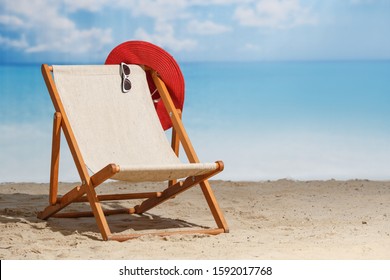 Beach sdeck chair on a sandy beach by the sea. Summer mood. Space to copy - Powered by Shutterstock