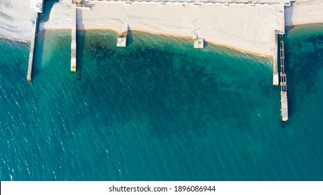 Beach And Sea Aerial View And Sun Beds. Above. Top View