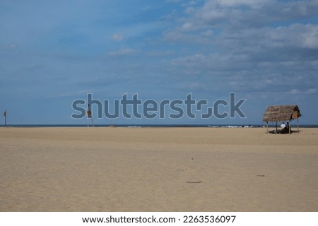 Beach  sea sand hut blue sky clouds India tourism Pondicherry  Beautiful scene