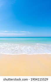 Beach And Sea. Sand On Sea Water Clear. Blue Sea Blue Sky Background. Vertical Photo Concept.