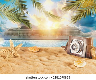 Beach with seashells, starfish, retro camera and a cruiseship