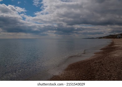 Beach With Small Pebbles And Clear Water. An Idealistic Seascape.