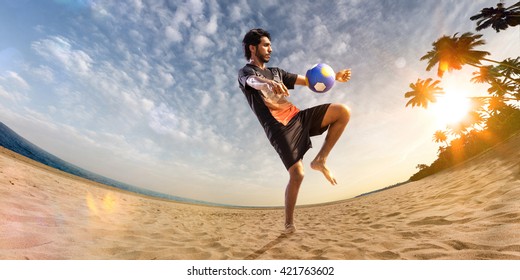 Beach soccer player in action. Sunny beach wide angle