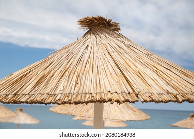 Beach Straw Umbrella On A Clear Sunny Day.