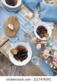 Beach Summer Picnic. Overhead Shot Of Wooden Board With Mediterranean Seafood Mussels, Oysters And Glasses Of White Wine, Table With Fresh Marine Food Decorated With Floral Arrangement