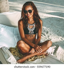 Beach summer portrait of beautiful tanned young woman in black b