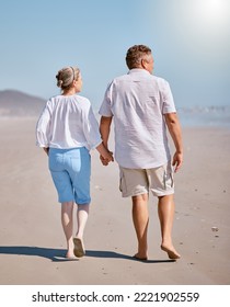 Beach, Summer And Senior Couple Walking For Exercise While On Vacation, Adventure Or Journey. Love, Holding Hands And Elderly Man And Woman Pensioners On Walk While On Retirement Holiday In Australia