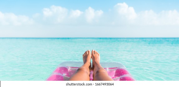 Beach Summer Vacation Woman Relaxing On Pool Float Taking Feet Selfie Pov Of Legs Sunbathing Relax On Pink Air Mattress Inflatable Toy Floating On Blue Ocean Background Panoramic Banner.