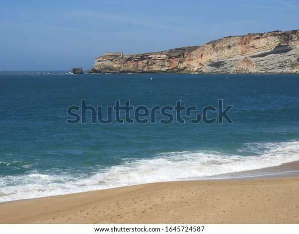 Nazaré beach in summer\
and winter time.