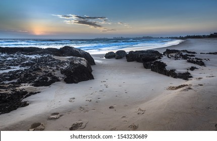 beach sunrise Currumbin gold coast beach sandy rocky coastal ocean shore cloudy early morning