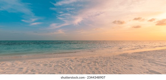 Beach sunset. Beautiful panoramic landscape, colorful golden sunset sky clouds. Closeup calm sea with waves splashing softly on sandy beach. Amazing sunrise landscape, summer nature, peaceful coast - Powered by Shutterstock