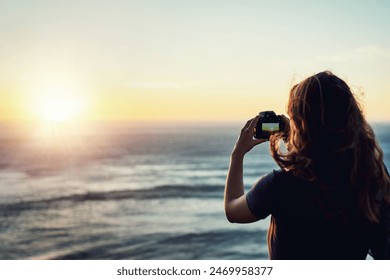 Beach, sunset or girl with camera in nature for photography, memory or scenic capture on summer, trip or vacation. Lens, sea or woman back with digital photo of ocean, water or sunrise travel moment - Powered by Shutterstock