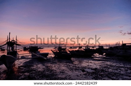 Beach Sunset Serenity. A tranquil beach scene at dusk with boats silhouetted against the horizon. Nature’s beauty in perfect harmony.