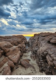 beach with sunset and stormy clouds