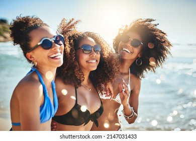 The beach sure is a beautiful place to be. Shot of a group of happy young women having fun together at the beach. - Shutterstock ID 2147031433