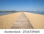 A beach surrounded by the sea on both sides. In the middle a wooden footbridge runs along the sandy beach. Natural spectacle of a Mediterranean landscape, Plaža Ždrijac, Nin, Zadar, Dalmatia, Croatia,