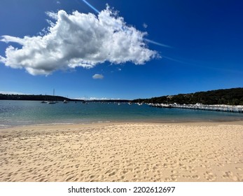 Beach In Sydney Harbour With Blue Sky And Boats