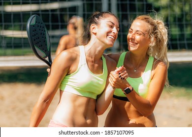 Beach tennis match greeting. Smiling Beach Tennis Players - Powered by Shutterstock