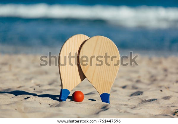 Beach tennis, beach paddle ball, matkot. Beach\
rackets and ball on the\
beach