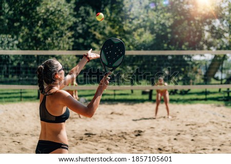 Beach Tennis Player Serving the Ball