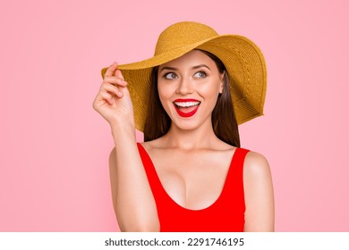 Beach time Close up portrait of girl holds a hat with one hand laughing and looking in the side isolated on yellow background - Powered by Shutterstock