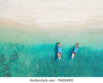Beach top view or aerial view with two long tail boat on emerald water