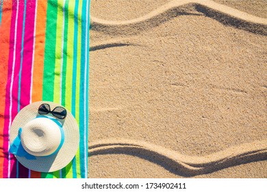 Beach Towel With Hat And Sunglasses Photographed From Above On Sunny Tropical Beach