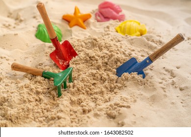 Beach Toys At Sandpit In Garden.