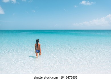 Beach Travel Caribbean Vacation. Bikini Woman Relaxing Sunbathing In Water Tanning Enjoying Sun. Winter Holidays.