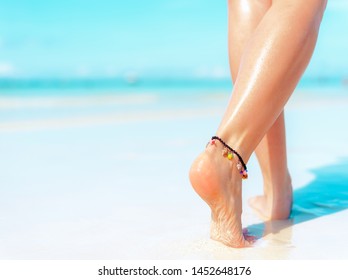 Beach Travel Concept. Sexy Legs On Tropical Sand Beach. Walking Female Feet. Closeup