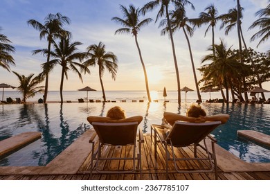 beach travel, couple relaxing on tropical beach at sunset in hotel, vacation and tourism