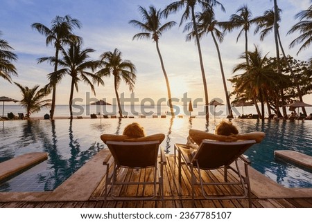 beach travel, couple relaxing on tropical beach at sunset in hotel, vacation and tourism
