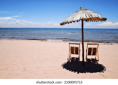 Beach Umbrella And Chairs With Lake Titicaca In The Background. No People At The Empty Beach On Taquile Island In Peru, South America.