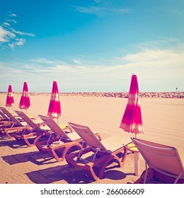 Beach Umbrella And Sun Bed In The Low Season Of The French Riviera, Vintage Style Toned Picture