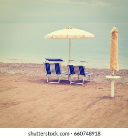 Beach Umbrella And Sun Bed In The Sandy Coast Near The Italian City Of Minori, Retro Effect