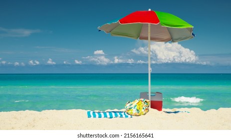 Beach, Umbrella, towel, cooler. bag. Miami Beach Florida. Atlantic Ocean. Summer vacations in Florida. Beautiful  Panorama of Island. View on Turquoise blue color of salt water. Beach sand. - Powered by Shutterstock